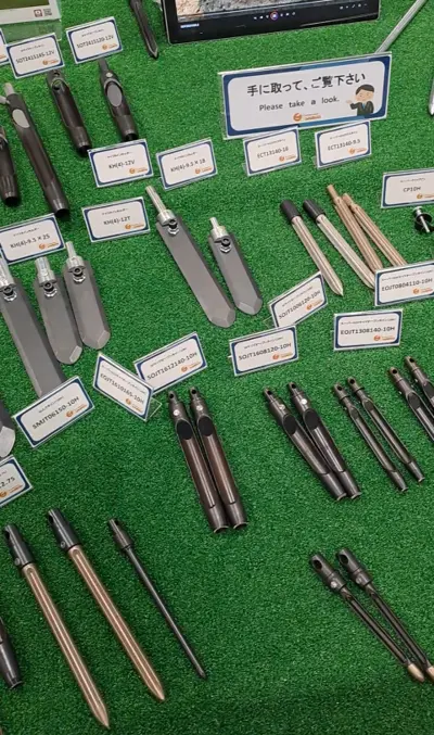 Aeration tines and blades on a table at the Japan Turf Show